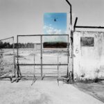 Nicola Bertasi, The entrance gate of the former Bien Hoa Airbase today. Overlayer: a rescue and recovery operation near Bien Hoa during the war, 2018, collage digitale / fotografia in bianco e nero, 120x120 cm, Edizione 1/3 + 3 PdA, Courtesy: dell’artista